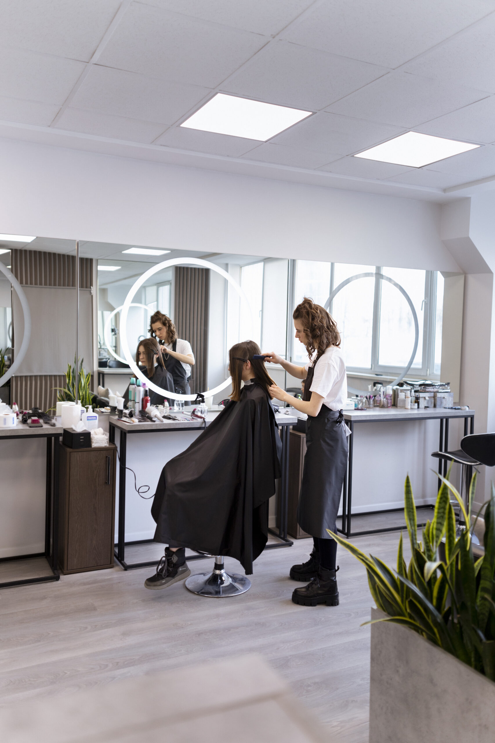 Woman getting hair styled at a luxury salon